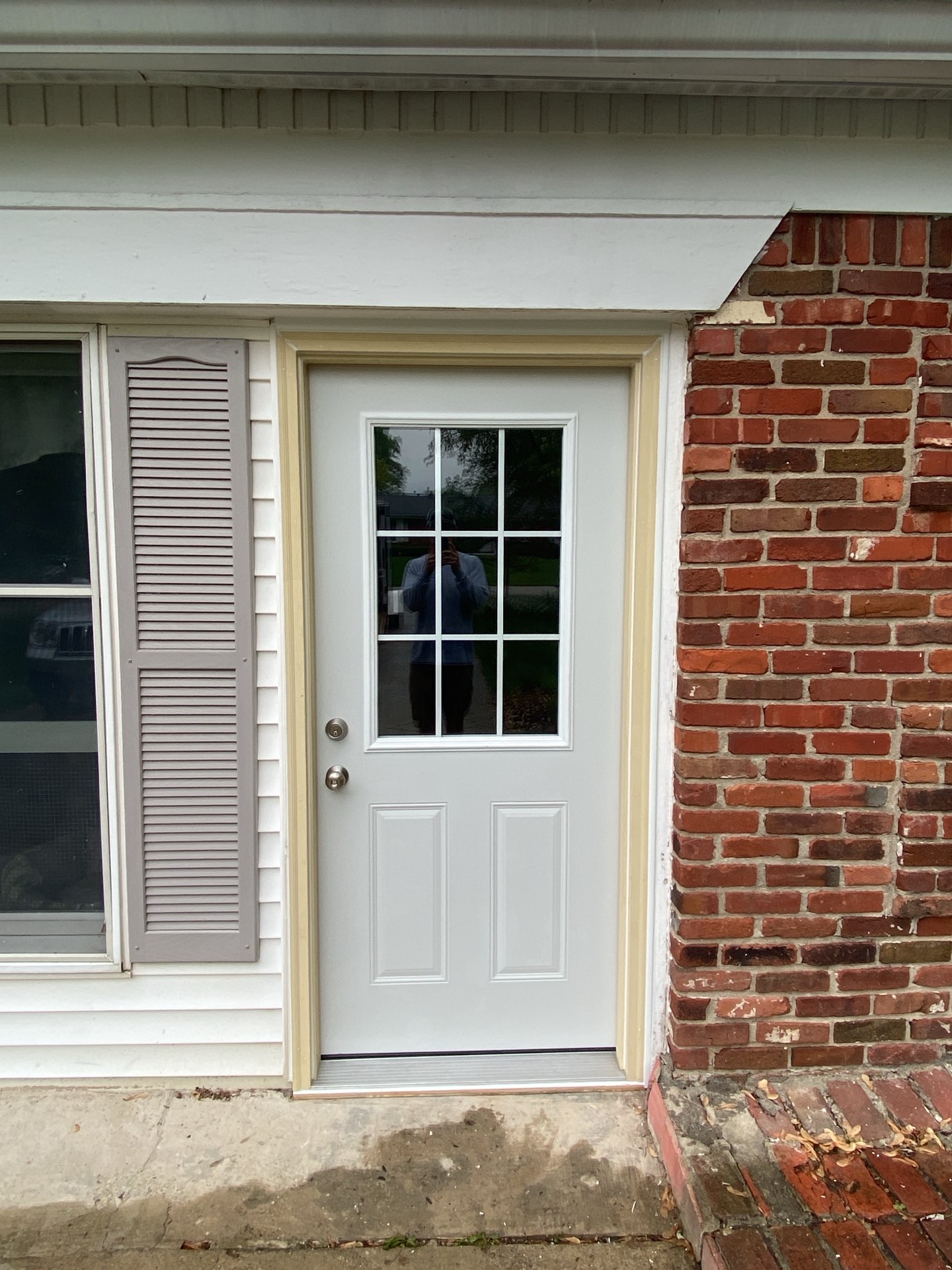 A white exterior door with windows