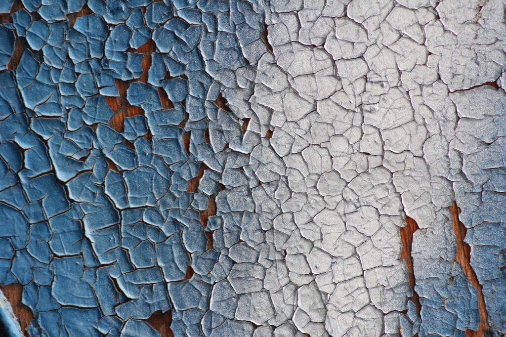 Paint cracking and peeling from the surface