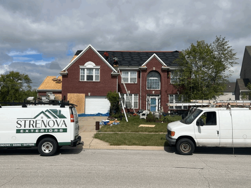 A two-story home’s roof is being replaced by the Strenova team