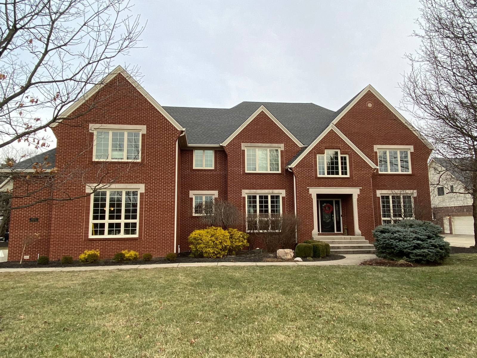 A charming, well-kept South Bend, IN home exterior with a lush green lawn